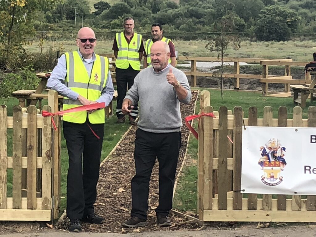 Standing left to right, Paul Swan Town Clerk, Councillor Doug Bushby Chair of Bideford Town Council S,F&GP Committee and Chair of Torridge District Council, Rear Town Rangers at Ford Rock Recreation Area, Opposite the entrance to Devonshire Park on the A386 South entrance to the Town.